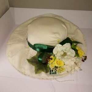 Tea party hat with a green ribbon and a ga…